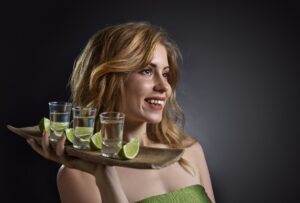 Beautiful woman with tequila .